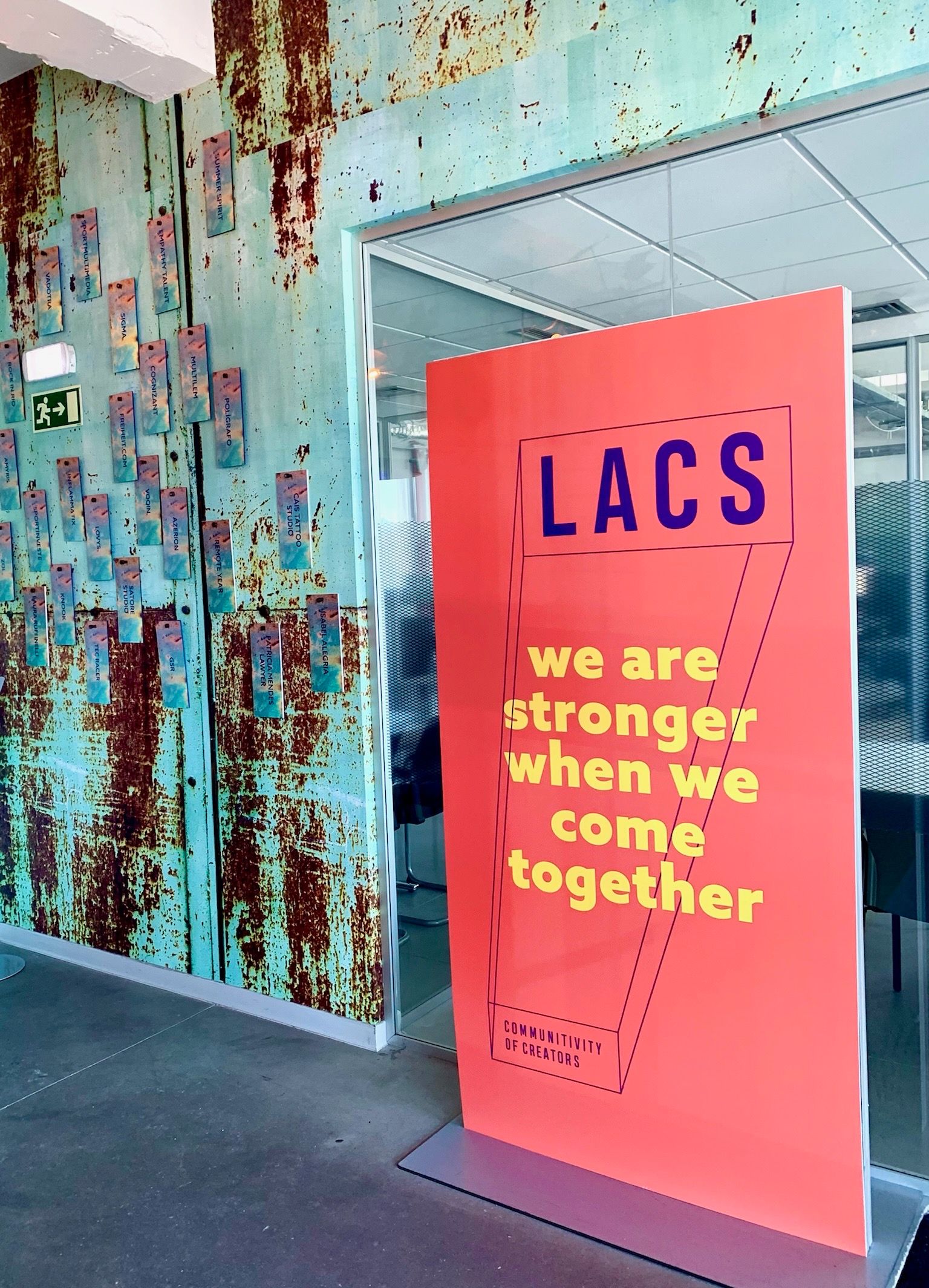 LACS sign in interior Lisbon building "we are stronger when we come together" red and yellow