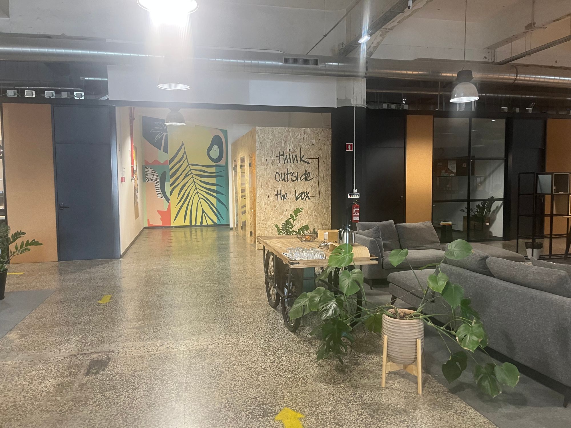 Workhub open office style interior with couches, plants and private offices