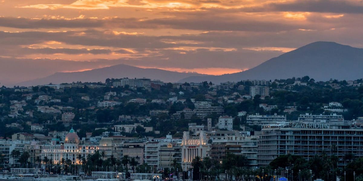 aerial photo of city beside body of water during sunset