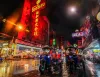 Bangkok at night with tuks tuks and neon signs
