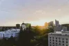 The skyline over Sacramento with buildings, capitol building, trees and sunlight