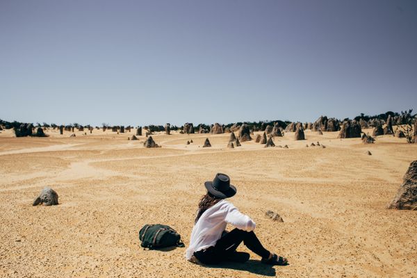 A digital nomad surveys a sandy landscape