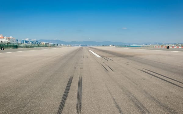 wheel marks on gray concrete pavement during daytime